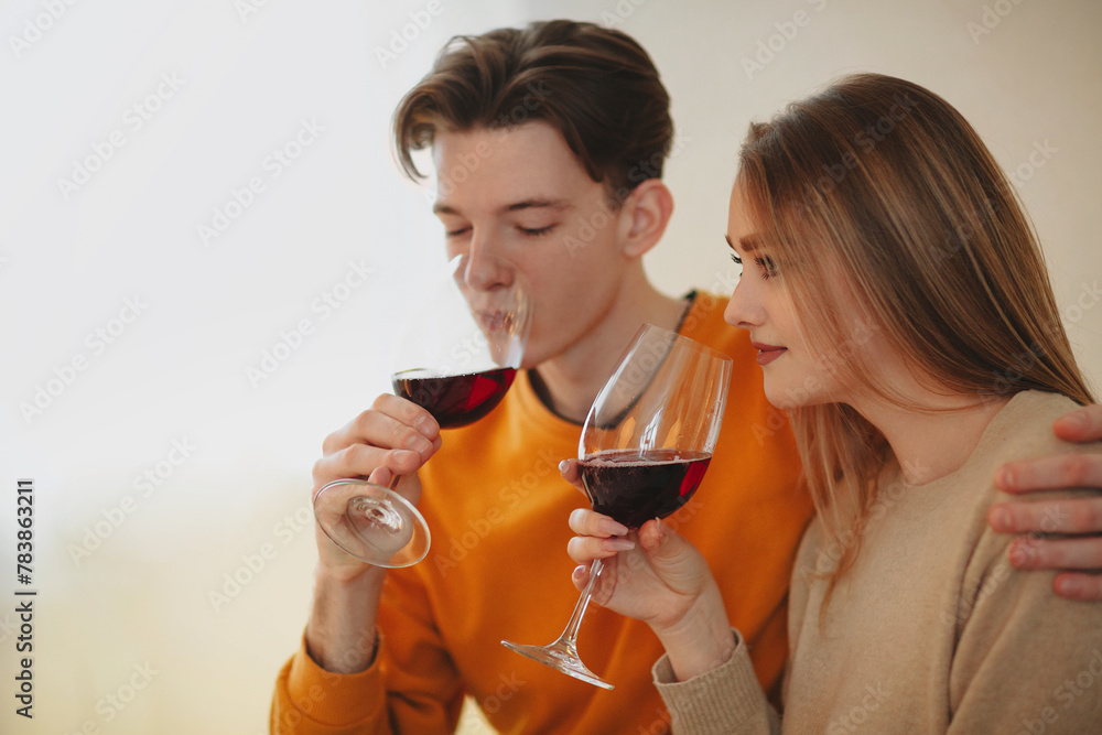 Young couple drinking wine at home Young couple drinking wine at home