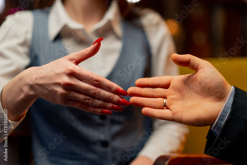 close-up of hands sitting in yellow office chairs businessman made deal with female director shaking hands © Guys Who Shoot