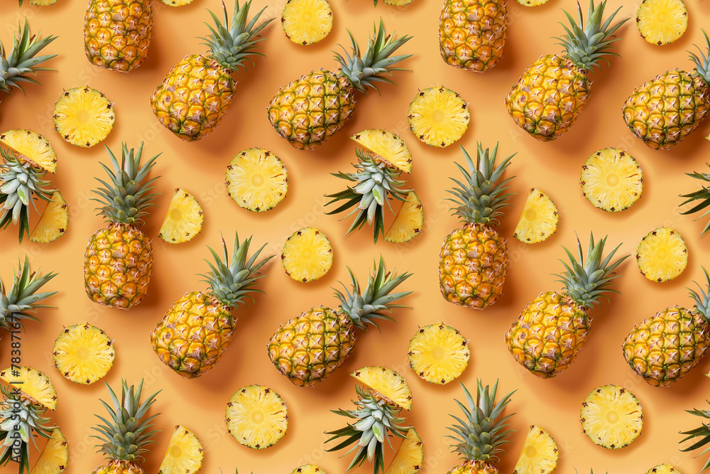 Fresh pineapple fruit arrangement on orange background Fresh pineapple fruit arrangement on orange background