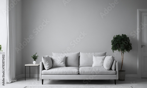 A white sofa stands in the living room by the window, allowing natural light to flood in.