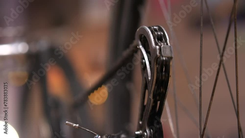 close-up of a bicycle sprocket gear shift gear against of a spinning wheel photo