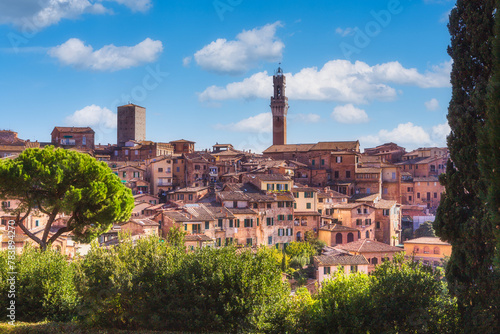 Beautiful view of campanile of Siena Cathedral, Duomo di Siena, and Old Town of medieval city of Siena in the sunny day, Tuscany, Siena province, Italy photo