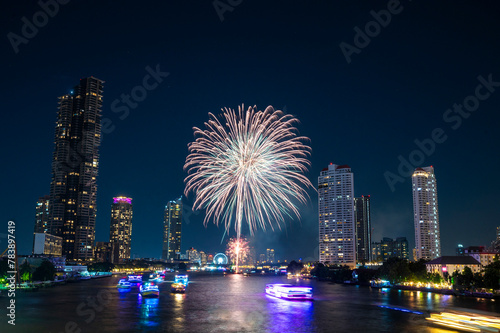 Landscape of firework at Taksin Bridge with chaopraya river. downtown Bangkok City Thailand. photo