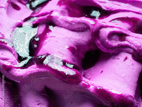 Frozen Blueberry flavour gelato - full frame detail. Close up of a violet surface texture of Ice cream covered with syrup.