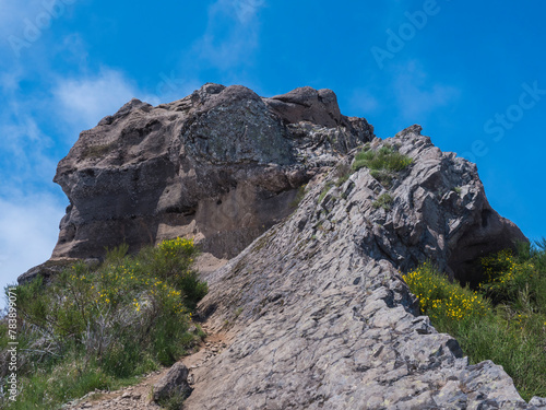 View of rocky top of Pico Grande one of the highest peaks in the Madeira over blue sky. Mountain landscape at hiking trail PR12, Madeira, Portugal © Kristyna