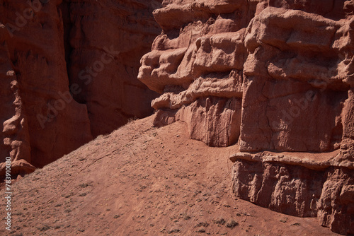 Rocky columns of red sandstone in canyon, aeolian deposits, result of soil erosion. weathering and washing away of rock. geology background