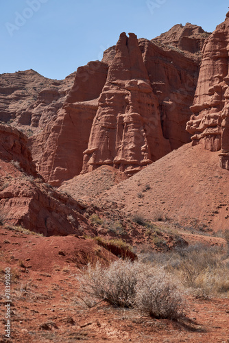 Konorchek canyon, sheer cliffs subject to erosion, trekking travel destination, famous landmark Kyrgyzstan, Central Asia. Rock formation, natural landscape, sandstone red rocks, hiking desert area