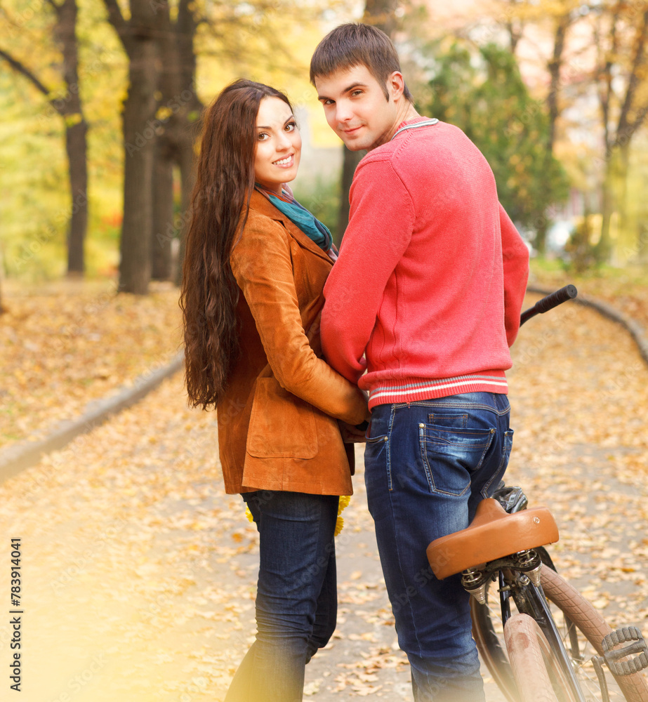 Couple with bicycle in autumn park Couple with bicycle in autumn park