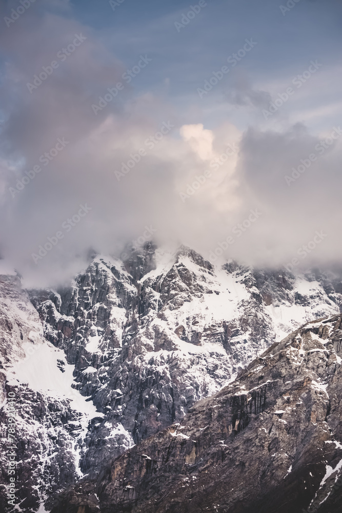 Texture of mountain ranges and peaks with snow and ice in the evening, in the Fan Mountains in Tajikistan, atmospheric evening landscape