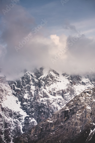 Texture of mountain ranges and peaks with snow and ice in the evening, in the Fan Mountains in Tajikistan, atmospheric evening landscape