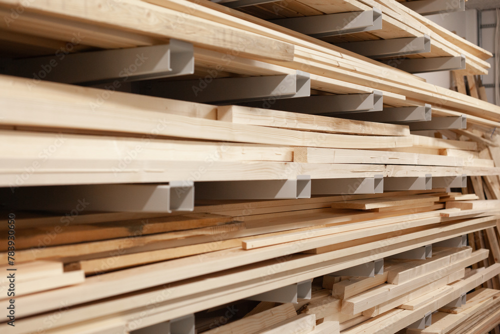 Stacked wood boards for machinery. Pine board beams stacked and organized at warehouse. Stacked wood boards for machinery. Pine board beams stacked and organized at warehouse.