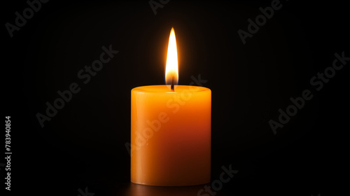 one orange colored burning candle on black background