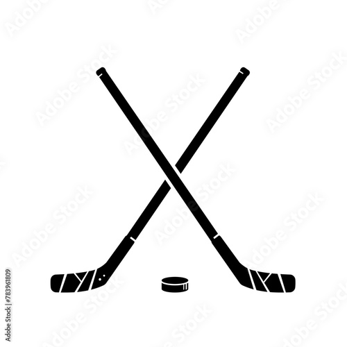 Hockey. Two crossed hockey sticks and puck - vector illustration