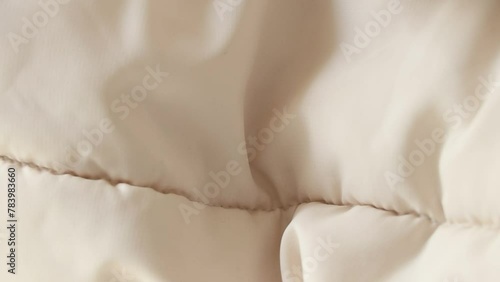 White puffy winter jacket as a background close-up, white background photo