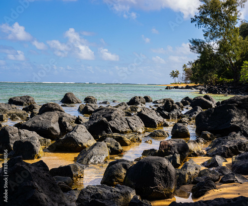 Lava Rocks and Sandy Shore of Anini Beach, Kauai, Hawaii, USA photo