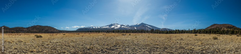 distant mountain panorama with meadow and afternoon blue skies distant mountain panorama with meadow and afternoon blue skies
