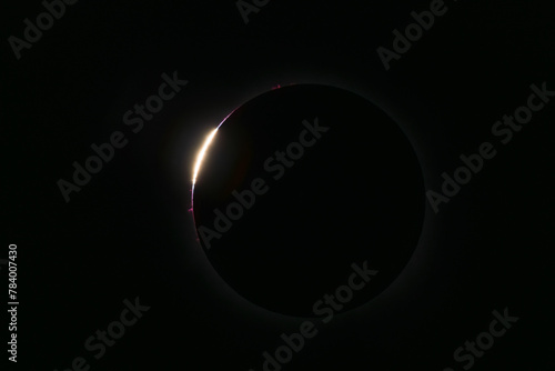 Total solar eclipse with bright Baily's beads, moon entrance