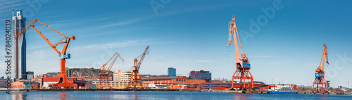 Gothenburg port loading cranes panorama against a backdrop of skyscrapers and blue skies, concept of maritime and industry. Gothenburg, Sweden photo