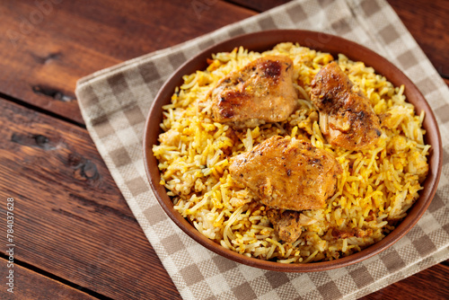 Pakistani and Indian Chicken Biryani Rice in Clay Bowl on Wooden Boards