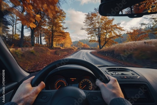 A person driving a car on a scenic country road. Ideal for transportation concepts