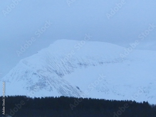 The Tromsdalstinden mountain is awe-inspiring as it rises high over the city of Tromso in northern Norway. photo