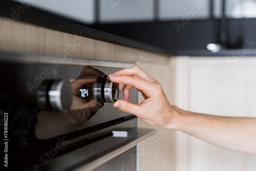 Woman hand regulate button, choosing microwave mode at modern oven