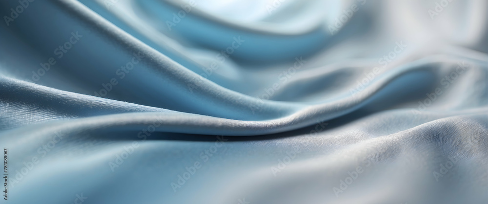 Obraz premium A high-resolution image capturing the delicate folds of a soft blue satin fabric, presenting an elegant and luxurious texture