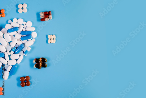 Medical pills in the form of heart and cardiogram, capsules on a blue background. concept of a healthy heart