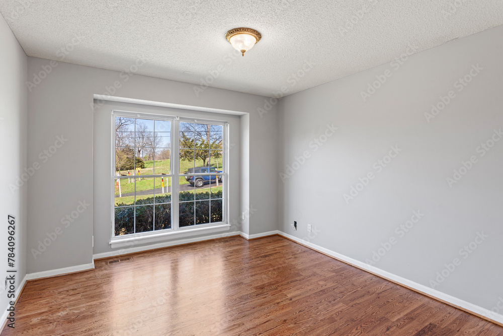 interior of simple ranch style home in the country with original oak hardwood floors, gray walls and white trim. Empty home. Stage with any furniture you would like. interior of simple ranch style home in the country with original oak hardwood floors, gray walls and white trim. Empty home. Stage with any furniture you would like.
