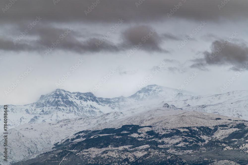 Panoramic view of Sierra Nevada (Granada, Spain) at sunset after a heavy snowfall in spring