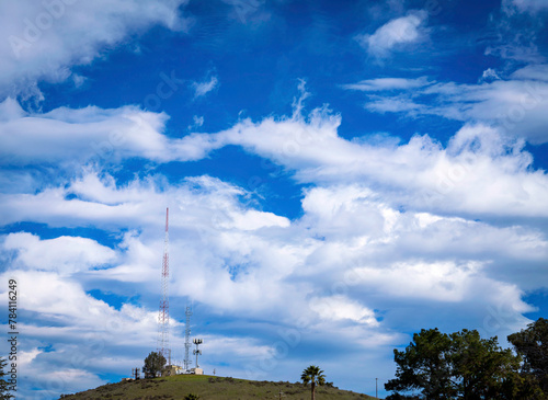 Clouds over antennas on hill, towers © Mark