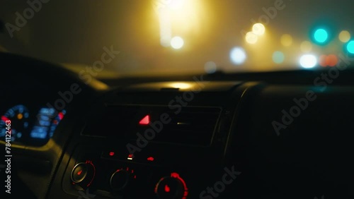 Mist-Enshrouded Path: Join the journey through the veil of mist on a foggy night, where the driver's adeptness with car lights and mirrors ensures safe passage. photo
