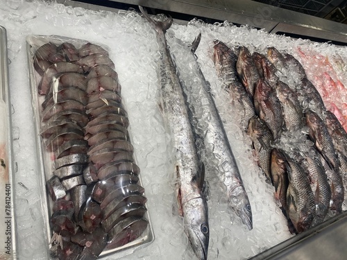 Cut fish Butter Fish, Mackerel , pomfret on display in ice in a fish market photo