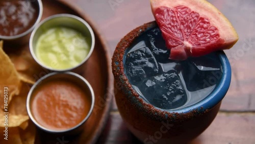 Mexican Refreshment: Cantarito Paloma Grapefruit Cocktail and Tortilla Chips from Above in 4K video photo