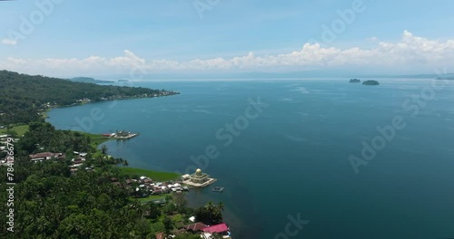 The coast of Lake Lanao with a village and a mosque. Lanao del Sur. Mindanao, Philippines. photo