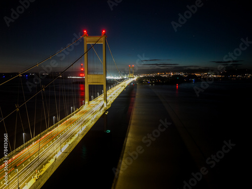 Nighttime aerial view of illuminated suspension bridge