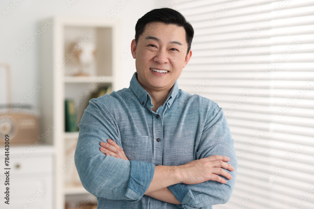 Portrait of smiling friendly businessman in office