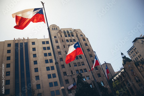 Bandeiras do Chile tremulando, , vistas de baixo para cima, em dia ensolarado no centro histórico de Santiago, Chile photo