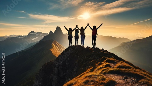Peak triumph silhouettes a top mountain, joyous group celebrates team success , embodying shared victories, harmonious collaboration, euphoria of collective achievement in nature's majestic embrace. #784160214