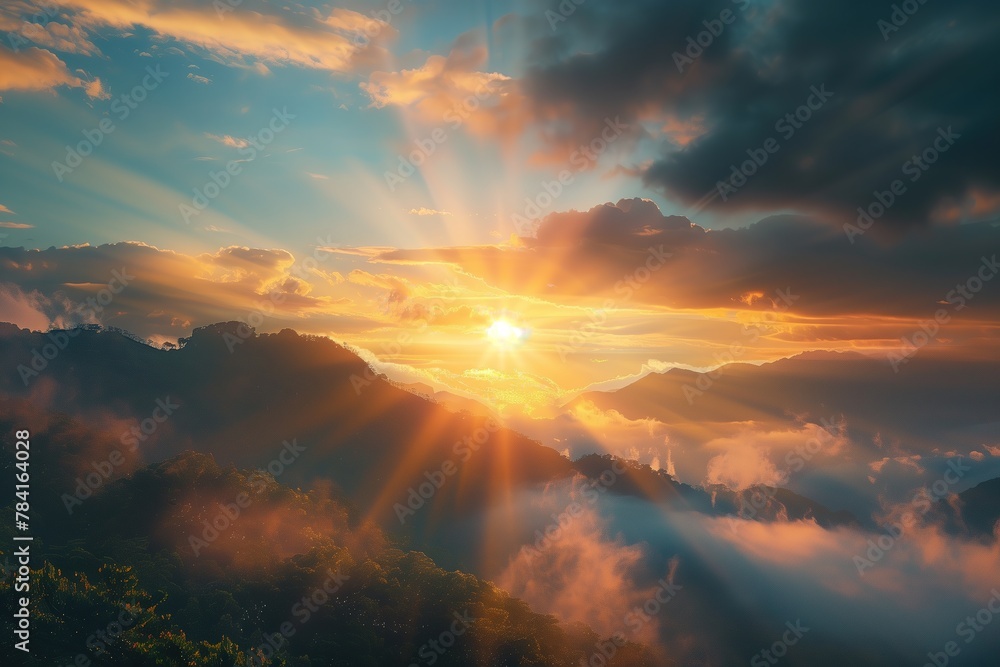 A beautiful sunrise with sun rays and fog over the mountain area