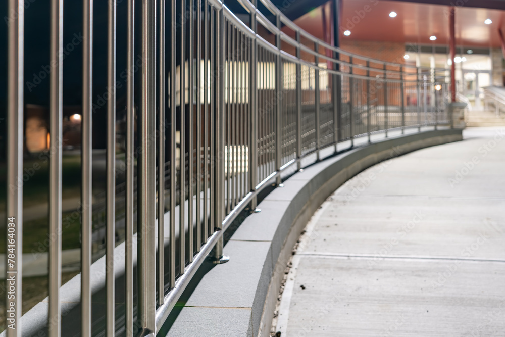 Example of a stainless steel railing along a concrete sidewalk, at the ...