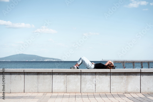Young woman resting on the parapet