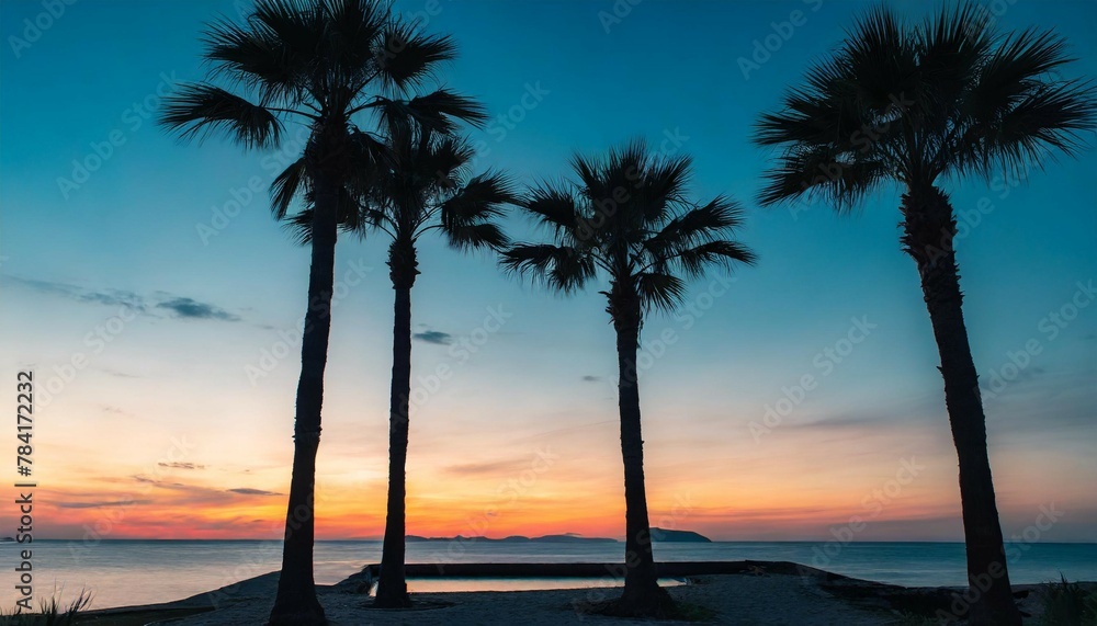 Silhouette of palm trees on sunset sky background