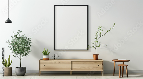 Empty poster frame mockup on white wall in cozy living room with wooden sideboard and green plant
