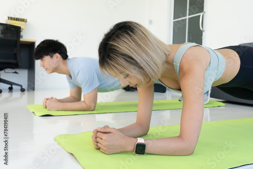 Young Asian Couple Workout at Home by Doing Plank