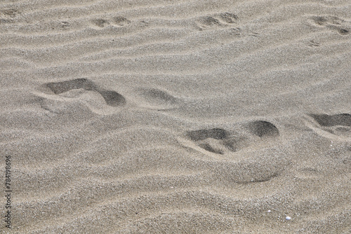 footprints in the beach sand. concept of summer vacation on a deserted beach.