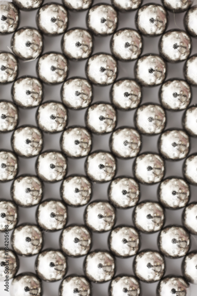magnetic ball bearing tiling in perfect hexagonal grid. Metal balls close up. Balls of neodymium (magnets). magnetic ball bearing tiling in perfect hexagonal grid. Metal balls close up. Balls of neodymium (magnets).