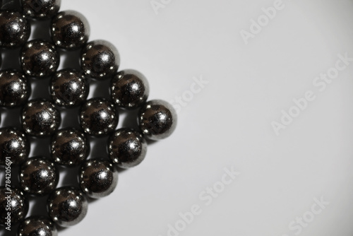 magnetic ball bearing tiling in perfect hexagonal grid. Metal balls close up. Balls of neodymium (magnets). photo
