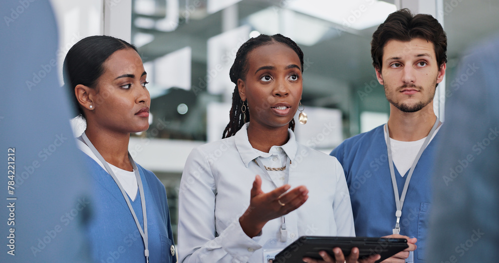 © peopleimages.com - Doctor, woman and consulting with tablet for medical planning, support or teamwork on investigation. Diversity, team and mentor with technology for clinic examination, surgery feedback or information