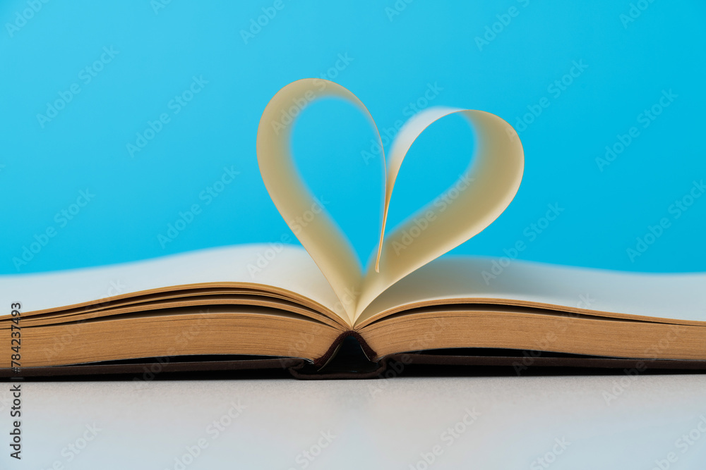 Book pages curved into heart shape Book pages curved into heart shape